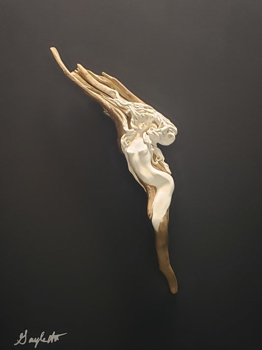 Female figure on driftwood